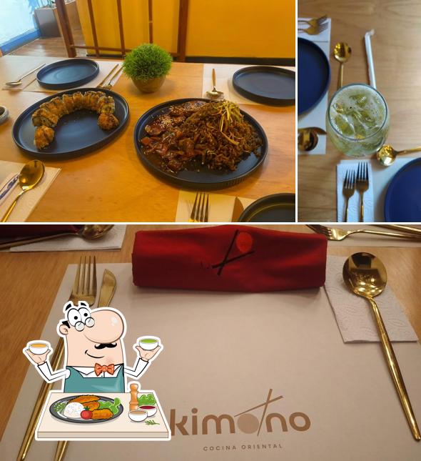 Table with oriental rolls and noodles — Kimono logo on napkin